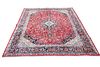 A FINELY WOVEN PERSIAN MASHAD CARPET, the red field with scrolling foliate 