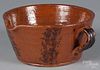 Pennsylvania redware spouted bowl, 19th c., with manganese decoration, 4 1/4'' h., 8 1/2'' dia.