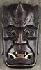Carved articulated mask, 20th c., with movable eyes and a tin tongue, 15'' h.
