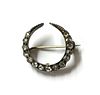 A silver and gold, diamond crescent brooch,