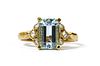 A gold aquamarine and diamond ring,