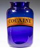 LARGE BLUE GLASS APOTHECARY JAR LABELED "COCAINE"