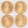 Four 1/4ozt fine gold American Eagle coins.