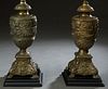 Pair of Brass Baluster Urns, late 19th c., with relief fruit and floral decoration. to a sloping floral relief square base on paw feet, now mounted on