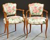 Pair of French Louis XV Style Carved Beech Armchairs, 20th c., the curved serpentine upholstered back over reeded scrolled arms to a bowed seat, on re