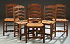 Set of Six French Provincial Carved Walnut Rush Seat Dining Chairs, 20th c., the arched ladder back over a trapezoidal rush seat, on reeded tapered sq