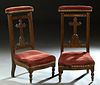 Pair of French Carved Beech Prie Dieus, 19th c., the curved upholstered armrest over a cruciform back splat, to a trapezoidal bowed seat, on turned le