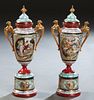 Pair of Porcelain Royal Vienna Style Covered Porcelain Urns, 19th c., with gilt and classical scenic reserves, on integral circular bases, H.-19 in., 