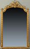 French Louis XVI Style Gilt and Gesso Overmantle Mirror, late 19th c., the arched top with a bow and garland surmount over an arched wide beveled mirr