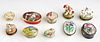 Group of Ten Porcelain Pillboxes, 20th c., five by Halcyon Days, and five museum replicas including a spaniel, two bunnies, and two floral relief. (10