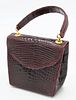 Giorgio's of Palm Beach Handbag, burgundy alligator clutch purse, new with tags, $2,950., having shoulder strap inside, height 5 inches, width 5 inche