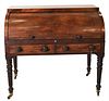 George III Mahogany Cylinder Roll Top Desk, having pull out leather writing surface over two drawers, on turned and fluted legs ending in brass castor