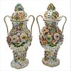 Pair of Porcelain Covered Urns, having molded flowers on body and covers, height 17 inches.