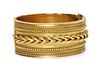 A cased Victorian gold archaeological revival, Etruscan style hinged bangle, c.1860,