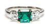 A platinum and gold three stone emerald and diamond ring, by Pravins, c.2002,