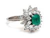An emerald and diamond three tier cluster ring,