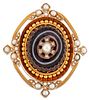 A VICTORIAN AGATE AND SPLIT PEARL BROOCH, a carved oval banded agate inset 