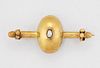 A SPLIT PEARL BAR BROOCH, an egg-shaped centre set with a split pearl to a 