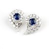 A pair of sapphire and diamond scrolled earrings