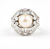 A natural pearl, diamond and platinum ring