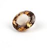 An unmounted orangy brown oval topaz