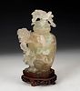 Potiche with flowers. China, XX century. 
Hand-carved translucent jade on wooden base.
