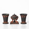 Three Wedgwood Black Basalt Items, England, 19th century, each with applied rosso antico in relief, a dolphin incense burner with cover and insert, ht
