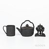 Three Wedgwood Black Basalt Items, England, 19th century, a cylindrical mug with wide oak leaf band, ht. 4 1/8; an oval shaped teakettle and cover wit