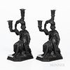 Two Wedgwood Black Basalt Diana Candleholders, England, 19th century, each two-light with foliate branches and candle nozzles, the seated figure with 