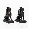 Pair of Wedgwood Black Basalt Seated Sphinx Candleholders, England, each modeled with a foliate molded candle nozzle set between their wings, impresse