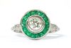 A platinum diamond and emerald target cluster ring,