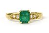 An 18ct gold emerald and diamond ring,