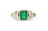 An 18ct white gold emerald and diamond ring,