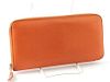 Hermes Orange Azap Wallet, the calf epsom leather with a silver accent zipper, opening two card holders, a zip pouch, and four bill compartments, H.- 