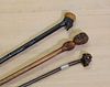 Three walking sticks with carved head handles,