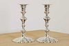 Two George II cast silver candlesticks,