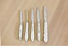 Five silver and mother-of-pearl folding fruit knives,