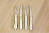 Two cased pairs of Victorian silver and mother-of-pearl folding fruit knives and forks,
