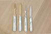 Two pairs of silver and mother-of-pearl folding fruit knives and forks in leather cases,