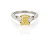 A fancy vivid yellow diamond ring