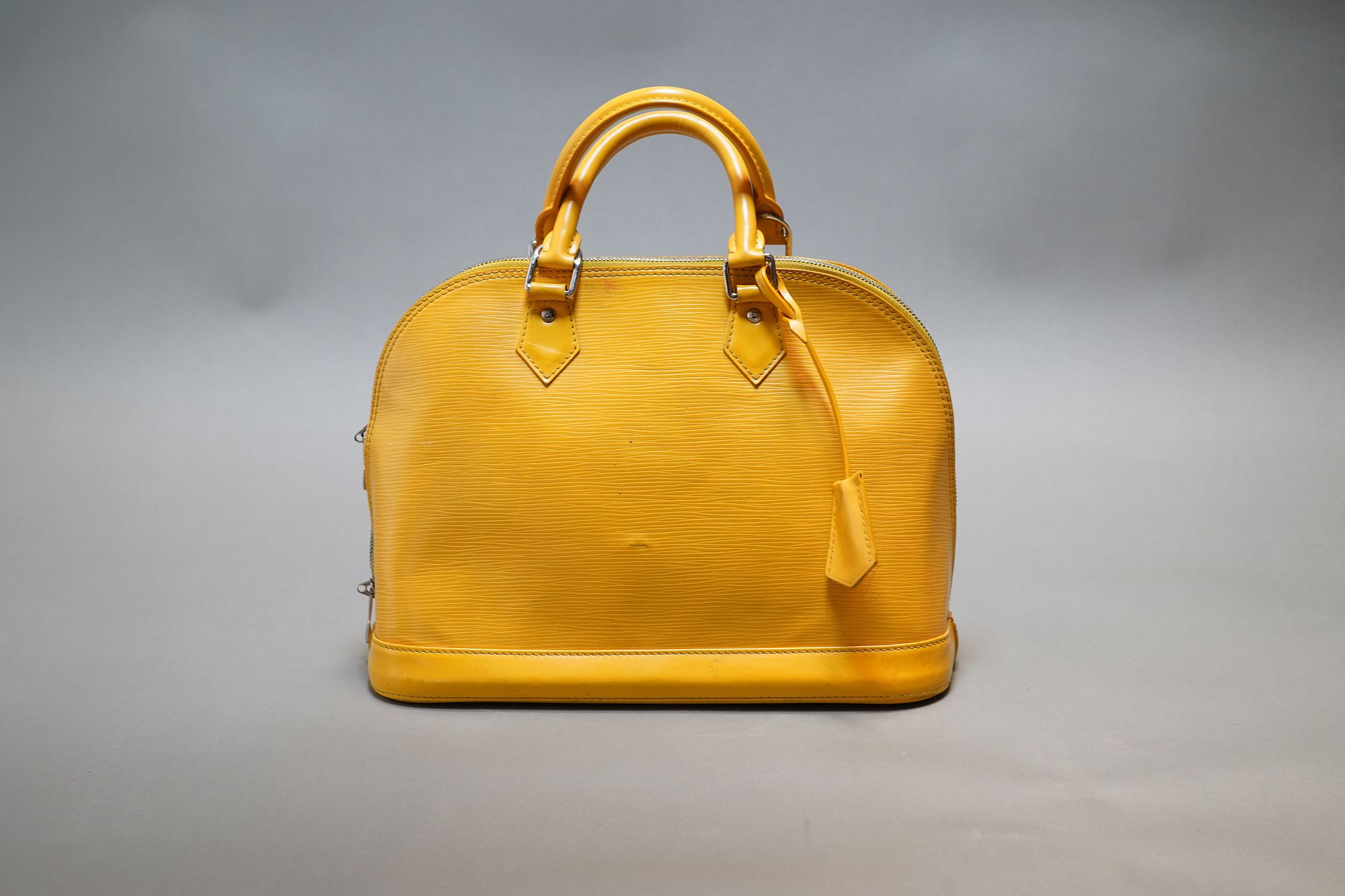 A LOUIS VUITTON YELLOW ALMA HANDBAG EPI LEATHER for sale at auction on 26th  August