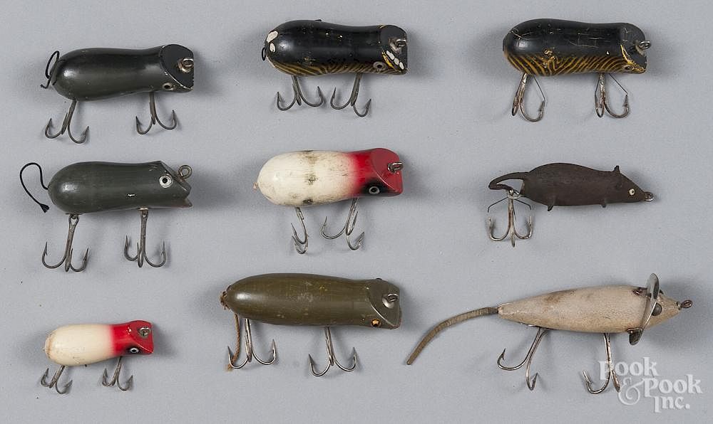 Seven Shakespeare wood mouse fishing lures, together with a Heddon